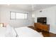 Well-lit bedroom features a ceiling fan, a window, a wooden dresser, and hardwood floors at 3046 Briarcliff Ne Rd # 7, Atlanta, GA 30329