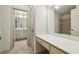 Light and bright bathroom with vanity, makeup table and a view to another bathroom at 9075 Preston Ln, Suwanee, GA 30024