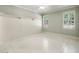 Light filled bedroom with white floors, wainscoting, built-in shelves, and shuttered windows at 9075 Preston Ln, Suwanee, GA 30024