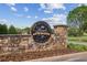 Laurel Springs golf club community sign on a stone wall with manicured flowers on a sunny day at 9075 Preston Ln, Suwanee, GA 30024