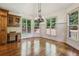 Bright dining area with large windows and a view of the wooded backyard at 9075 Preston Ln, Suwanee, GA 30024