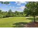 Scenic view of the expansive golf course featuring sand traps and lush green fairways under a bright sky at 9075 Preston Ln, Suwanee, GA 30024