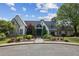 Elegant home exterior featuring stone and stucco, complemented by lush landscaping and a charming entrance at 9075 Preston Ln, Suwanee, GA 30024