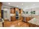 Bright kitchen with stainless steel appliances, granite countertops, and hardwood floors at 9075 Preston Ln, Suwanee, GA 30024
