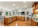 Open kitchen with granite countertops, stainless steel appliances, and view of the dining and living areas at 9075 Preston Ln, Suwanee, GA 30024