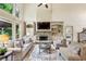 Inviting living room with a stone fireplace, built-in shelving, and lots of natural light at 9075 Preston Ln, Suwanee, GA 30024