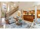 Open-concept living space with staircase leading to second story, kitchen area, and outdoor views at 9075 Preston Ln, Suwanee, GA 30024