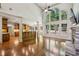 Bright and airy living room with soaring ceilings, large windows, and a cozy stone fireplace at 9075 Preston Ln, Suwanee, GA 30024