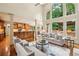 Open-concept living space flows into the kitchen with tall windows and access to the outdoors at 9075 Preston Ln, Suwanee, GA 30024