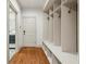 Functional mudroom with built-in storage and hardwood floors, adjacent to the laundry room at 9075 Preston Ln, Suwanee, GA 30024
