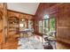 Spacious home office boasts hardwood floors, custom built-ins, and large window with plantation shutters at 9075 Preston Ln, Suwanee, GA 30024