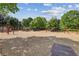 Community playground with swings, slides, and climbing structure under the shade of mature trees at 9075 Preston Ln, Suwanee, GA 30024