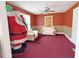 View of living room with vintage furniture and red carpet at 1683 Candler Rd, Decatur, GA 30032