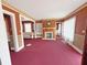 Cozy living room with fireplace, built-in shelving, red carpet, and natural light at 1683 Candler Rd, Decatur, GA 30032