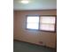 Bedroom featuring green carpet, peach colored walls and a double window at 4141 Fredericksburg Dr, College Park, GA 30337