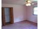 Small bedroom with closet, pink carpet, and ceiling fan at 4141 Fredericksburg Dr, College Park, GA 30337