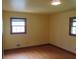 Bedroom with hardwood floors, yellow walls and two windows with blinds at 4141 Fredericksburg Dr, College Park, GA 30337