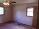 Bedroom featuring pink walls, pink carpet and two windows with blinds at 4141 Fredericksburg Dr, College Park, GA 30337
