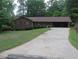 Charming single-story brick home featuring a covered driveway and a well-maintained front yard at 4141 Fredericksburg Dr, College Park, GA 30337