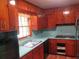 A traditional style kitchen featuring wooden cabinets, a stainless sink and laminate countertop at 4141 Fredericksburg Dr, College Park, GA 30337