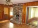 Cozy living room with a brick fireplace, hardwood floors, and wood paneling at 4141 Fredericksburg Dr, College Park, GA 30337