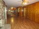 Open living room and kitchen with wood floors and wood paneling at 4141 Fredericksburg Dr, College Park, GA 30337