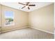 Carpeted bedroom with a ceiling fan, and large window allowing natural light at 1016 Borrington Ln, Stockbridge, GA 30281