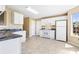 Well-lit kitchen featuring modern appliances, white cabinetry, and tile flooring at 1016 Borrington Ln, Stockbridge, GA 30281