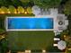 Aerial view of a backyard featuring a rectangular pool, lounge areas, patio, and lush landscaping at 1016 Wildwood Ne Rd, Atlanta, GA 30306