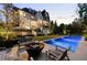 An outdoor oasis with a sparkling pool, fire pit, and elegant seating area perfect for entertaining guests at 1016 Wildwood Ne Rd, Atlanta, GA 30306