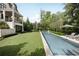 A backyard featuring rear of house, sparkling pool, a lounge area, and manicured landscaping at 1016 Wildwood Ne Rd, Atlanta, GA 30306