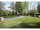 An expansive backyard with a pristine pool, lounge area, and well-manicured landscaping at 1016 Wildwood Ne Rd, Atlanta, GA 30306