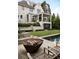 Backyard featuring the rear of house, a patio with a fire pit, and a sparkling swimming pool at 1016 Wildwood Ne Rd, Atlanta, GA 30306