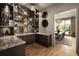 Stylish bar area with mirrored backdrop, ample storage, marble countertops, and decorative lighting at 1016 Wildwood Ne Rd, Atlanta, GA 30306