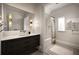 Well-lit bathroom with black vanity, a large mirror, and a shower-tub combination with a striped rug at 1016 Wildwood Ne Rd, Atlanta, GA 30306