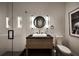 Modern bathroom features a black vanity, round mirror, sleek lighting, and tiled walk-in shower at 1016 Wildwood Ne Rd, Atlanta, GA 30306