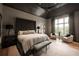 Elegant bedroom featuring a paneled ceiling, a large bed, stylish seating, and a bay window offering scenic views at 1016 Wildwood Ne Rd, Atlanta, GA 30306