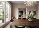 Elegant dining room with large windows, modern chandelier, and view to the living room at 1016 Wildwood Ne Rd, Atlanta, GA 30306
