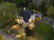 Stunning two-story home with a beautiful pool and lush landscaping, illuminated for evening enjoyment at 1016 Wildwood Ne Rd, Atlanta, GA 30306