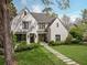 Elegant white brick home with a well-manicured lawn and stone walkway leading to the entrance at 1016 Wildwood Ne Rd, Atlanta, GA 30306