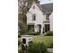 Elegant white brick home featuring lush landscaping, a stone walkway, and an inviting entrance at 1016 Wildwood Ne Rd, Atlanta, GA 30306
