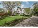 Beautifully landscaped front yard leading to a charming white brick home with classic design at 1016 Wildwood Ne Rd, Atlanta, GA 30306