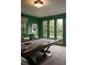 Game room with a pool table, stylish light fixture, and view of landscaped backyard at 1016 Wildwood Ne Rd, Atlanta, GA 30306
