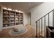 Elegant hallway with hardwood floors, a built-in bookshelf, and a modern ottoman at 1016 Wildwood Ne Rd, Atlanta, GA 30306