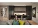 Modern kitchen with dark cabinetry, an island with seating, and a stylish accent wall at 1016 Wildwood Ne Rd, Atlanta, GA 30306