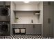 Well-organized laundry room featuring new front load washer and dryer and modern cabinets at 1016 Wildwood Ne Rd, Atlanta, GA 30306