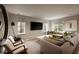 Contemporary living room with a large sofa, TV, modern chairs, and natural light at 1016 Wildwood Ne Rd, Atlanta, GA 30306
