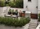 Backyard patio features an outdoor kitchen, dining area, and lush landscaping at 1016 Wildwood Ne Rd, Atlanta, GA 30306