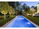 Stunning backyard featuring a rectangular pool, manicured landscaping, and inviting lounge areas at 1016 Wildwood Ne Rd, Atlanta, GA 30306
