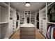 Well-organized walk-in closet featuring built-in shelving, drawers, and a central island with a marble countertop at 1016 Wildwood Ne Rd, Atlanta, GA 30306